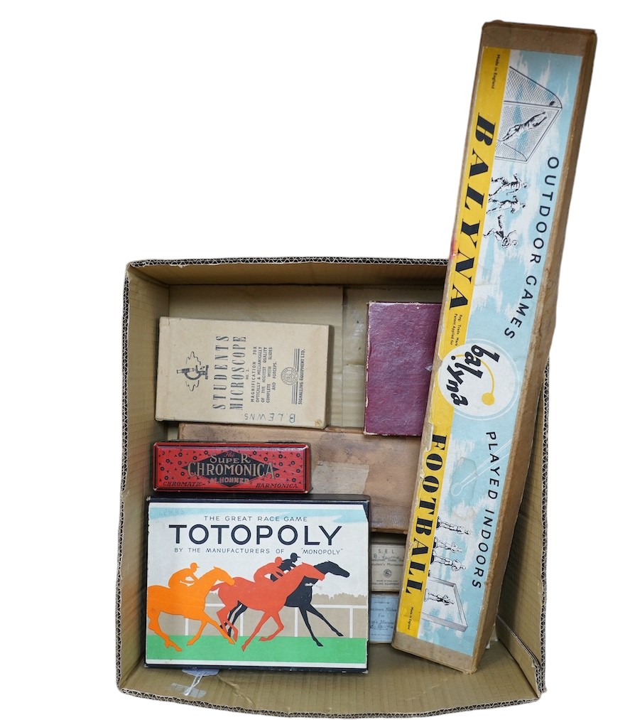 Eight 20th century to mid 20th century toys etc. including; an early boxed Subbuteo table soccer goal post set, a student microscope with slides, a boxed Balyna table football set, a Totopoly board game, a leatherworking